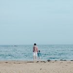 Man and toddler on beach. Photo by Kelly Sikkema on Unsplash.